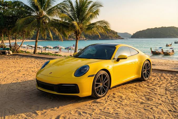 Yellow Porsche 911 on a Phuket beach